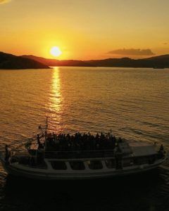 Sunset boat party during Skiathos nightlife 2025 with a full crowd on board