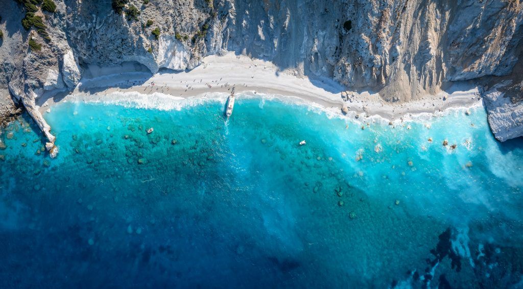 Aerial view of Lalaria Beach Skiathos with boats and turquoise waters