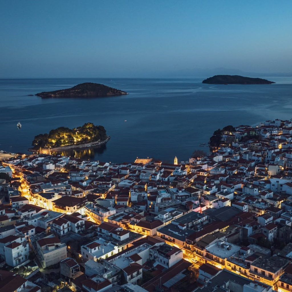 Skiathos nightlife 2025 — aerial view of Skiathos Town lighting up before the party begins