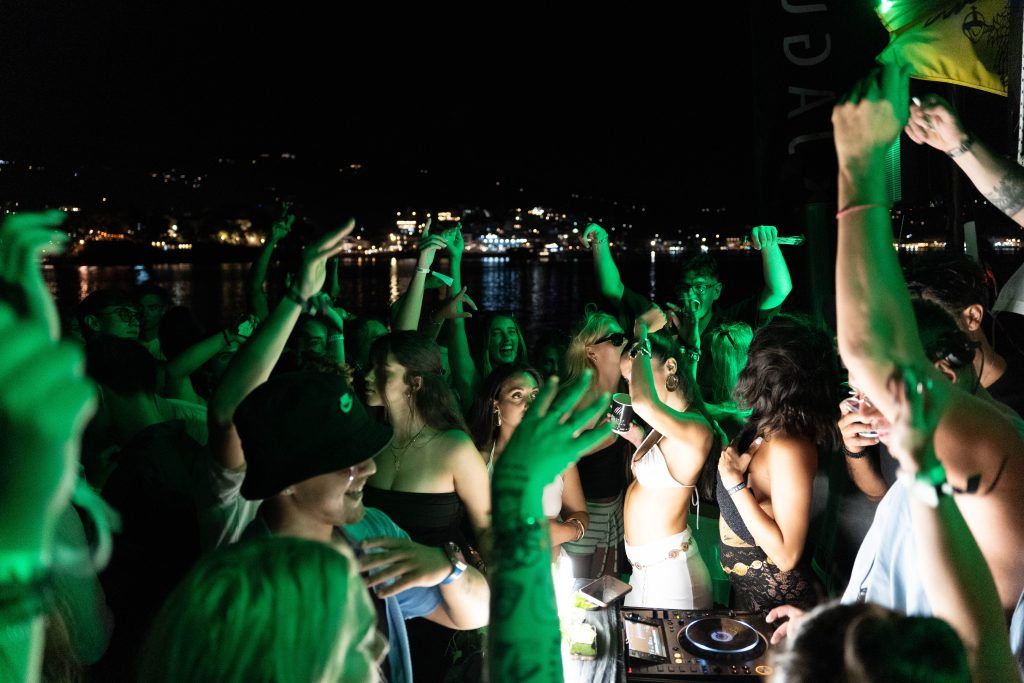 Oasis Boat Party Skiathos crowd dancing under the night sky with DJ