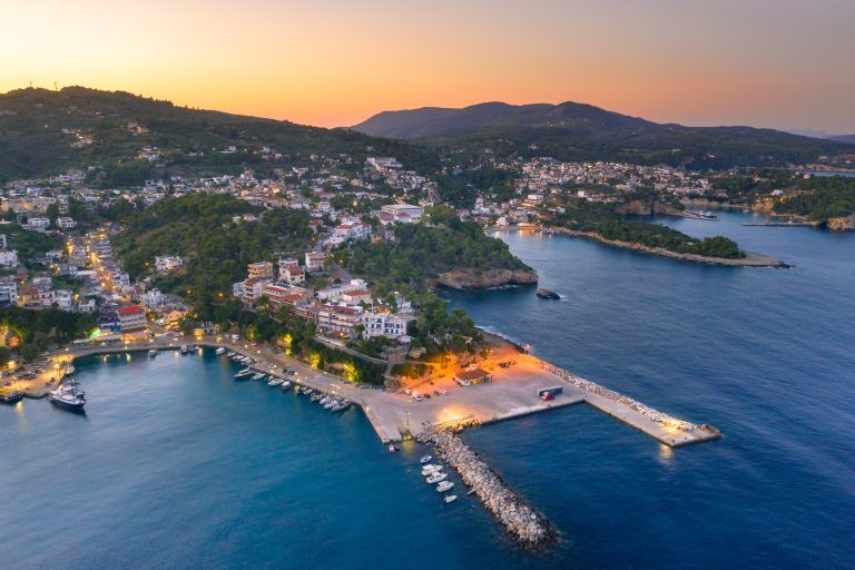 Sunset over Alonnisos harbour and seaside promenade