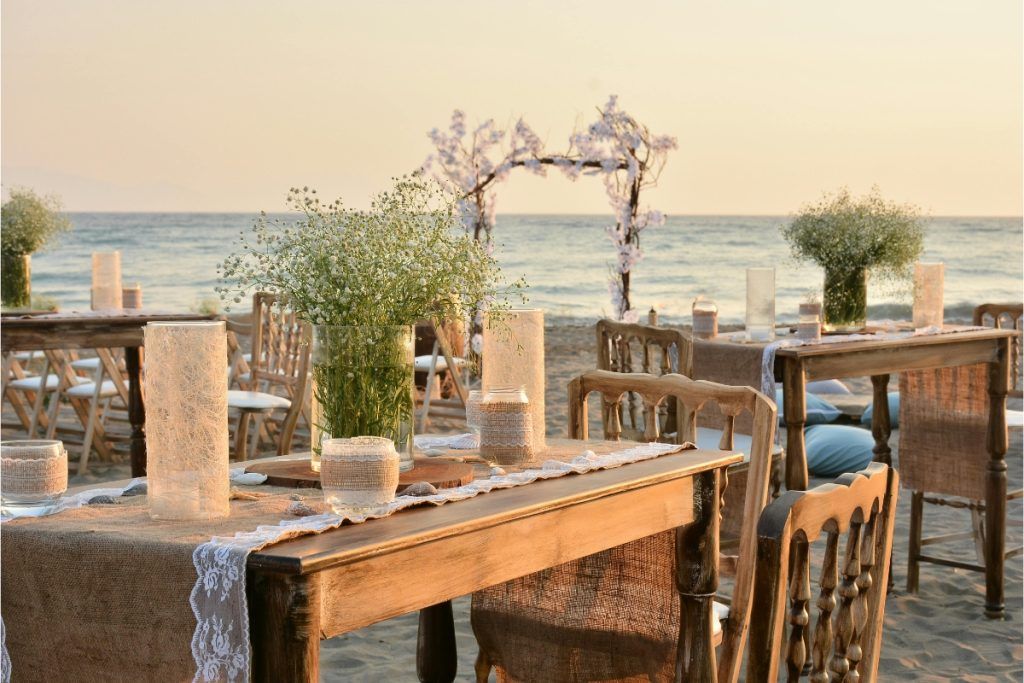 Beach event setup with decorated tables in Skiathos organized by Skiathos Travellers for private and corporate events