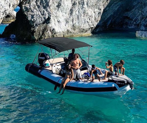 Private boat rental Skiathos 2026, family enjoying Lalaria arch by boat