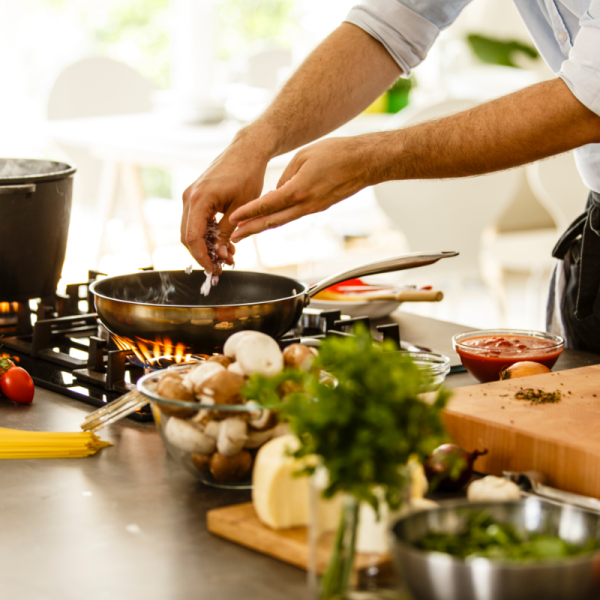 Private chef cooking fresh Mediterranean dishes in a villa kitchen in Skiathos.