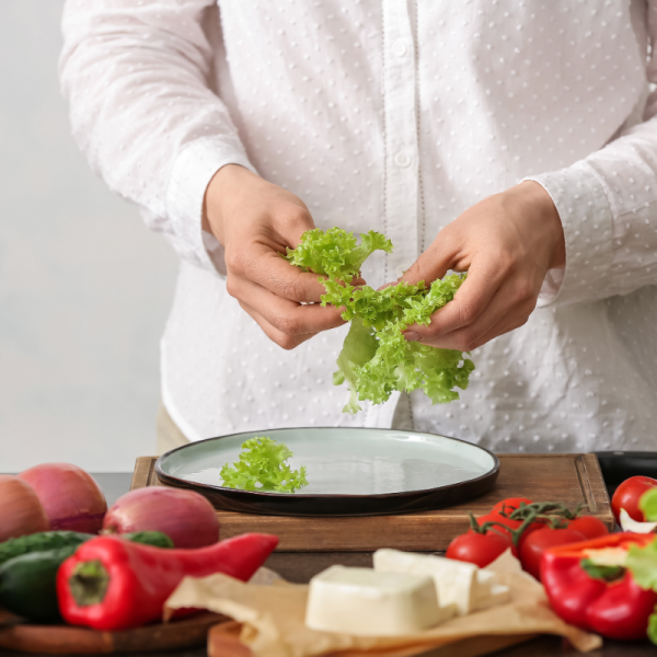 Preparing traditional Greek dishes with fresh ingredients during a Skiathos cooking class.