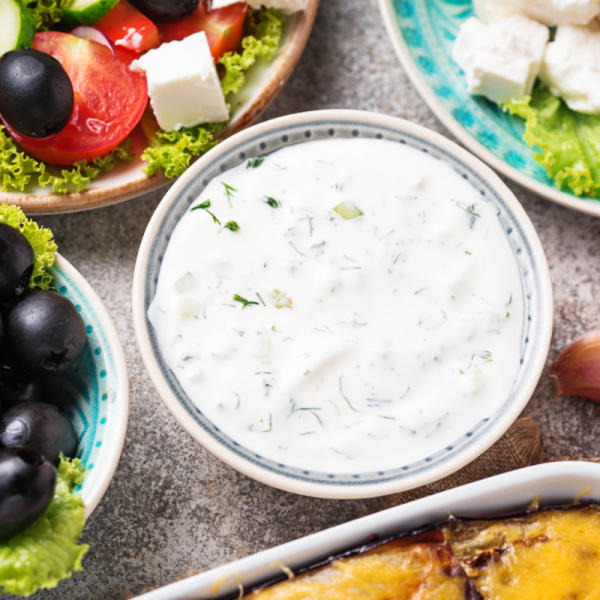 Traditional Greek dishes prepared during a Skiathos cooking lesson, featuring tzatziki, feta, and local vegetables.