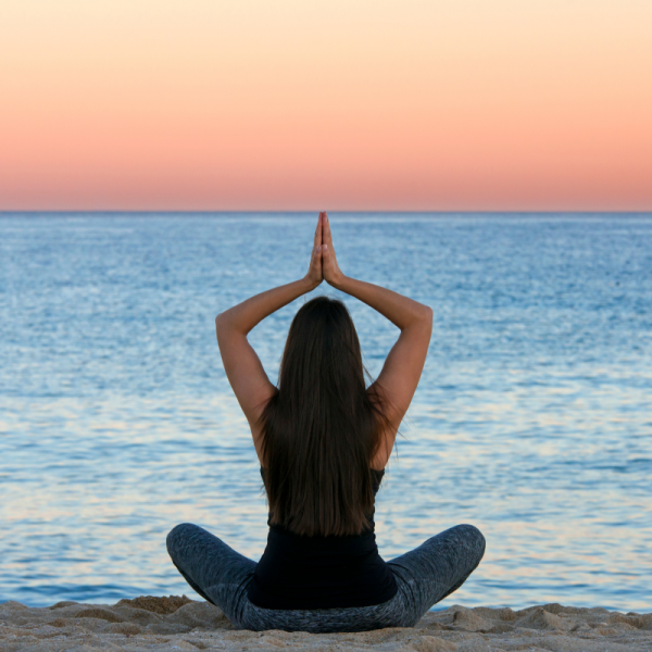 Peaceful yoga meditation moment outdoors with soft morning light and sea breeze